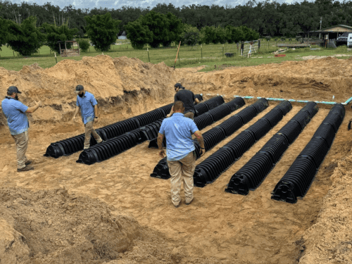 LCI crew setting drain field chambers for a large septic system