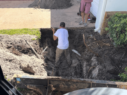 Excavation beside a home for a septic system repair