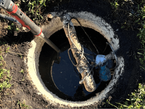 Septic tank being pumped through the access lid by LCI